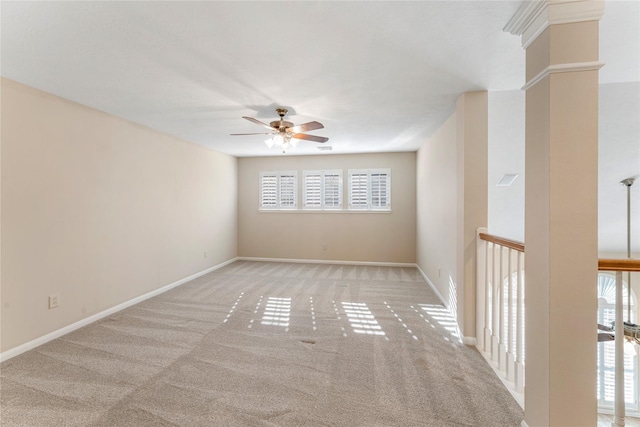 carpeted empty room featuring ceiling fan and baseboards