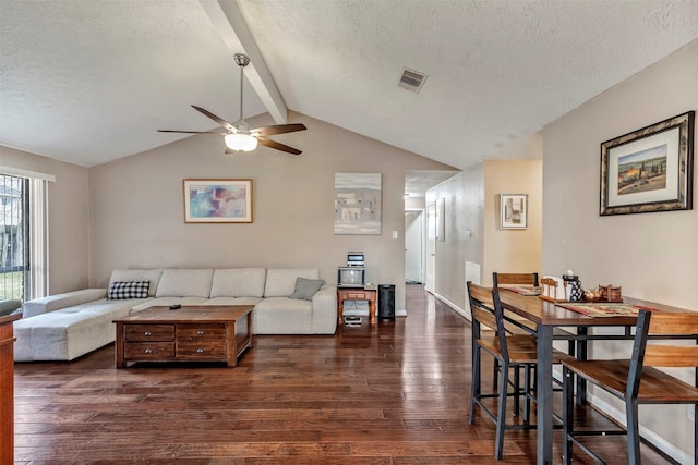 living room featuring visible vents, a ceiling fan, wood finished floors, vaulted ceiling with beams, and a textured ceiling