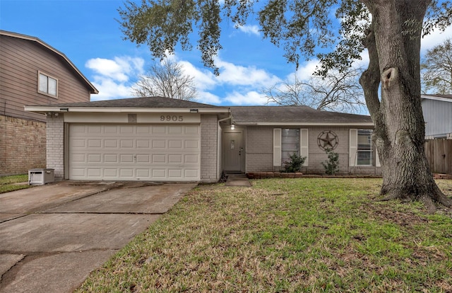 single story home featuring a garage, concrete driveway, brick siding, and a front lawn