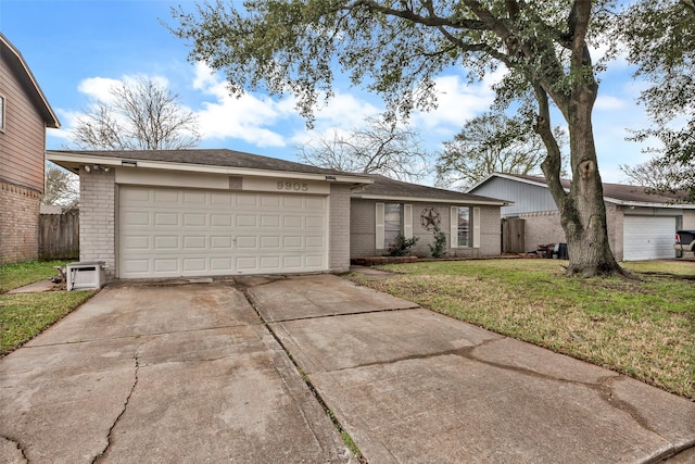 single story home featuring a garage, concrete driveway, brick siding, and a front lawn