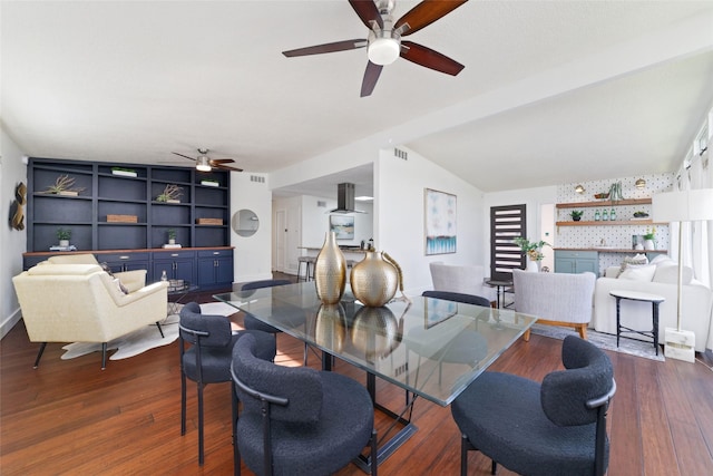 dining space featuring a ceiling fan, lofted ceiling, dark wood-style floors, and visible vents