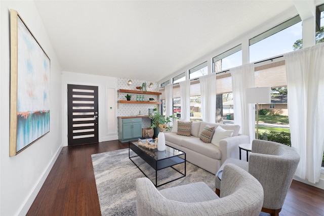 living area featuring dark wood finished floors, plenty of natural light, and baseboards