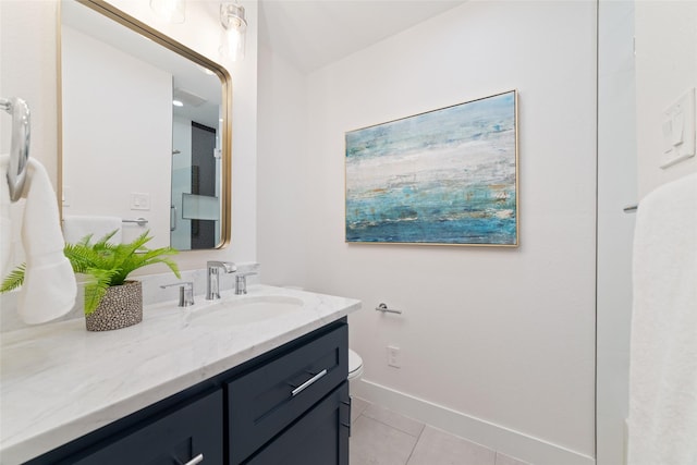 bathroom with tile patterned flooring, vanity, and baseboards