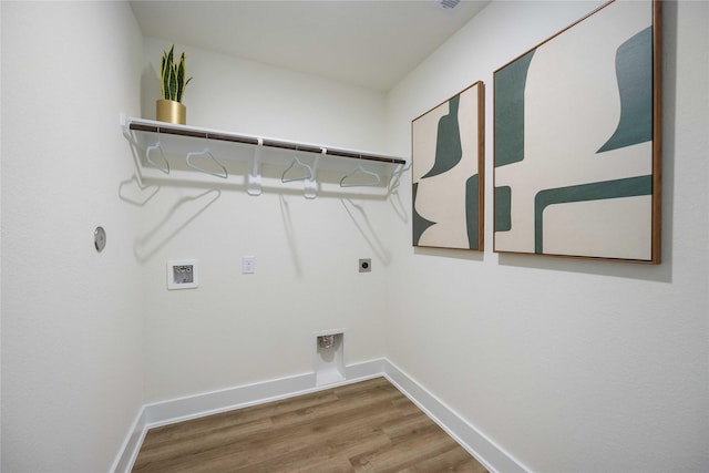 laundry room featuring laundry area, baseboards, wood finished floors, hookup for a washing machine, and hookup for an electric dryer