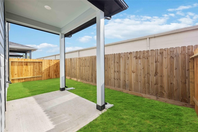 view of yard featuring a patio area and a fenced backyard