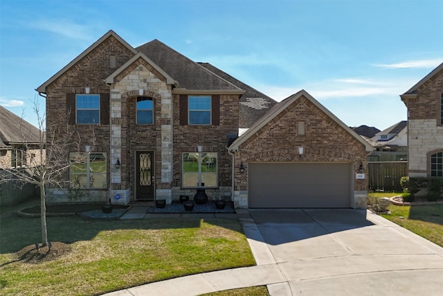 french country inspired facade with a garage, brick siding, concrete driveway, roof with shingles, and a front yard