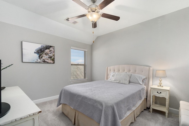 bedroom featuring baseboards, visible vents, light colored carpet, ceiling fan, and vaulted ceiling