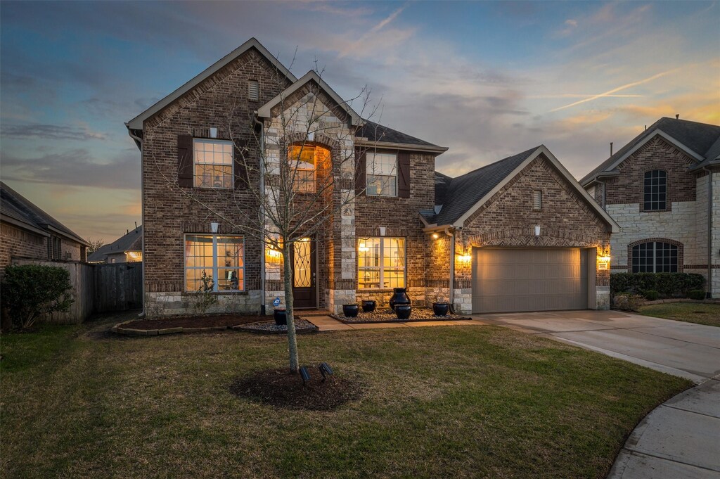 2618 Mystic Springs Ln, League City, TX 77573 - french provincial home with an attached garage, brick siding, fence, driveway, and a yard