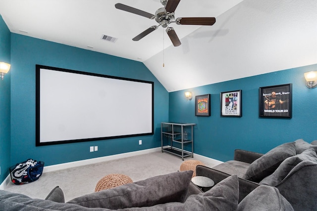 home theater with visible vents, carpet flooring, vaulted ceiling, ceiling fan, and baseboards