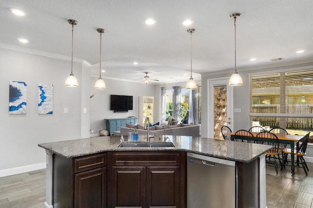 kitchen featuring a sink, light wood finished floors, ornamental molding, and stainless steel dishwasher