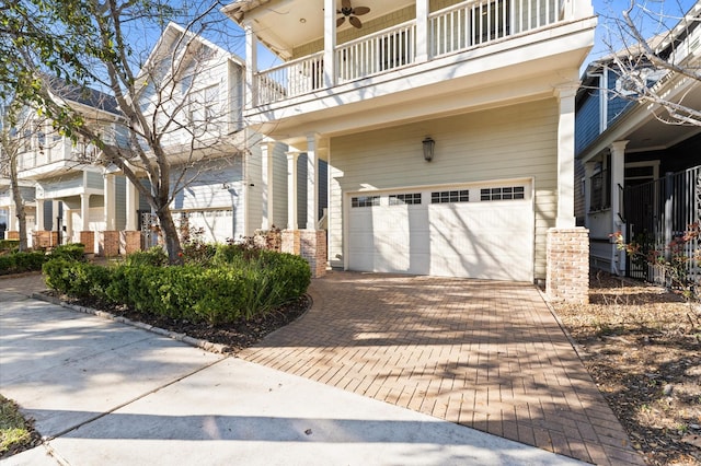 view of property exterior with decorative driveway and an attached garage