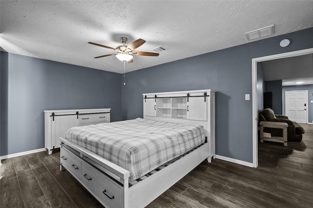 bedroom featuring dark wood finished floors, visible vents, and baseboards