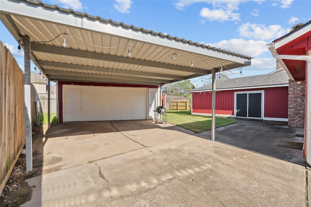 exterior space featuring a detached garage and fence