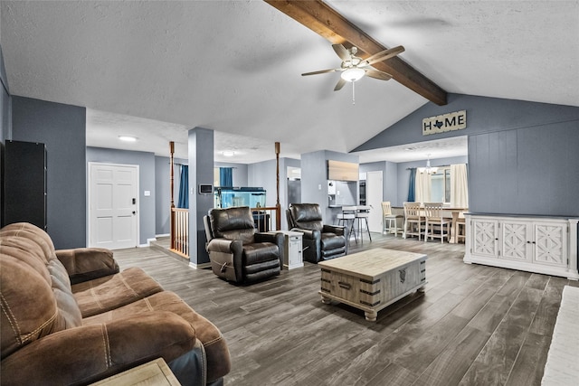 living room featuring lofted ceiling with beams, dark wood-style floors, a textured ceiling, and ceiling fan with notable chandelier