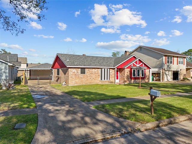 view of front of property with a gate, a front lawn, and brick siding