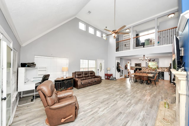 living area featuring ceiling fan with notable chandelier, lofted ceiling, and wood finished floors