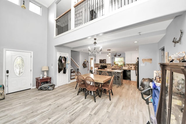 dining area featuring a notable chandelier and light wood-style flooring