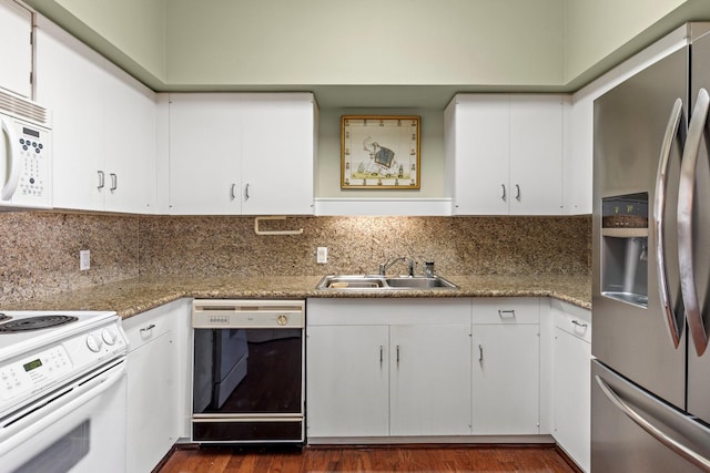 kitchen featuring white appliances, a sink, and white cabinets