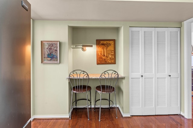 interior space with baseboards and wood finished floors