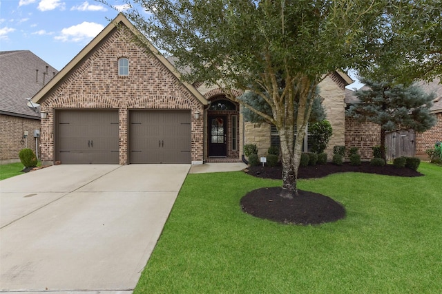 view of front of property with a garage, a front yard, concrete driveway, and brick siding