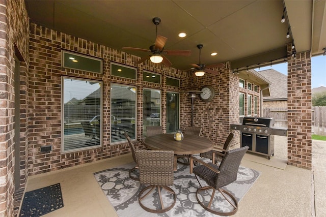 view of patio with a ceiling fan, outdoor dining area, fence, and area for grilling