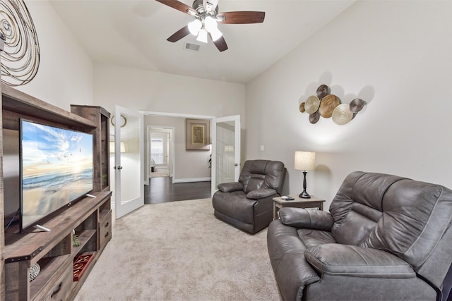 carpeted living area with ceiling fan, visible vents, and baseboards