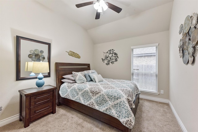 bedroom featuring light carpet, baseboards, vaulted ceiling, and a ceiling fan