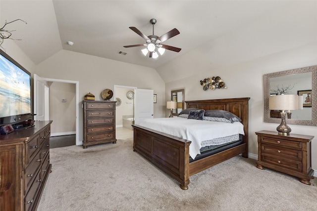 bedroom with light carpet, baseboards, visible vents, lofted ceiling, and ensuite bathroom