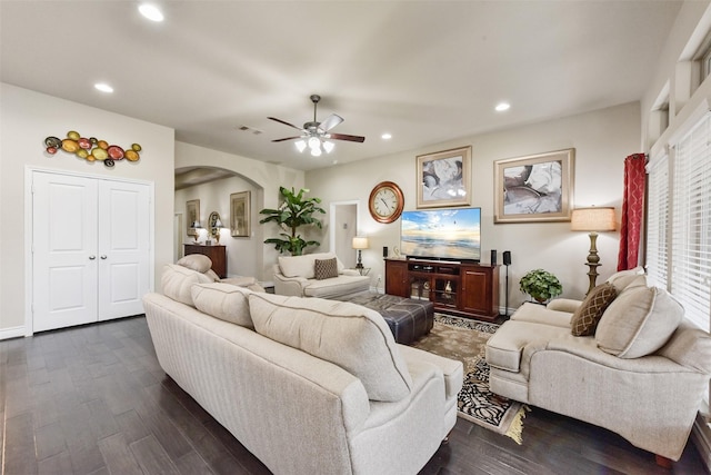 living area with visible vents, arched walkways, ceiling fan, dark wood-type flooring, and recessed lighting