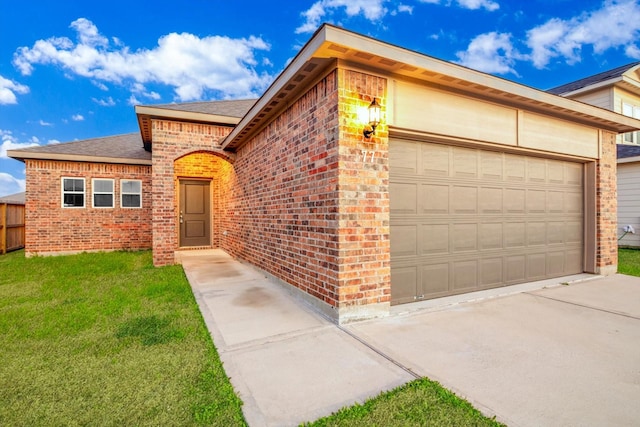 view of front of house featuring a front lawn, concrete driveway, brick siding, and an attached garage