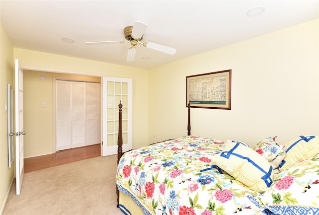 bedroom with ceiling fan and light colored carpet