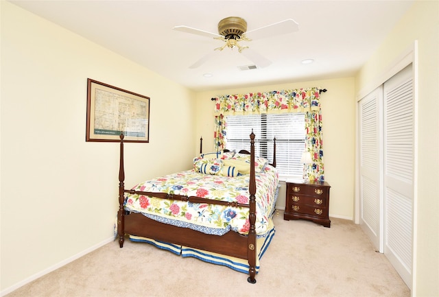 carpeted bedroom with a ceiling fan, a closet, visible vents, and baseboards