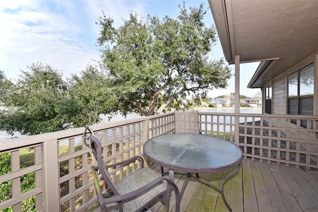 wooden terrace featuring a water view