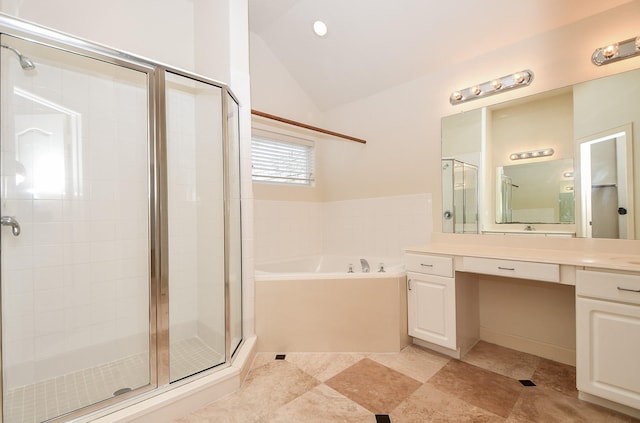 bathroom featuring a stall shower, a garden tub, lofted ceiling, and vanity