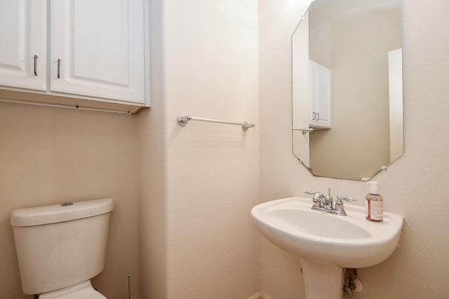 half bath with a sink and toilet