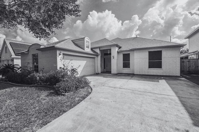 ranch-style house with a garage, driveway, roof with shingles, fence, and brick siding