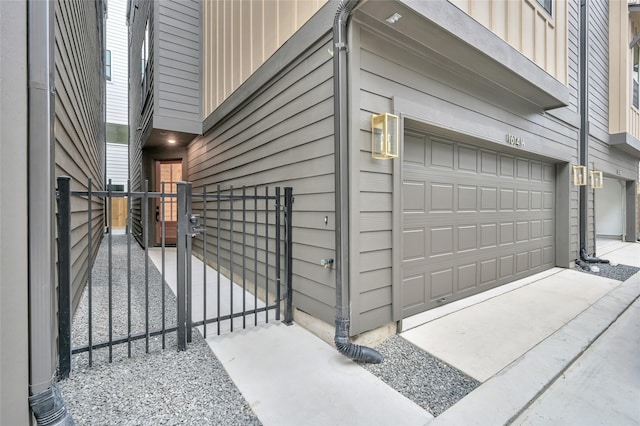 garage featuring fence and a gate