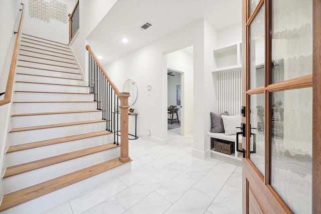 foyer with marble finish floor, recessed lighting, visible vents, stairway, and baseboards