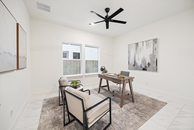 home office with a ceiling fan, marble finish floor, visible vents, and baseboards