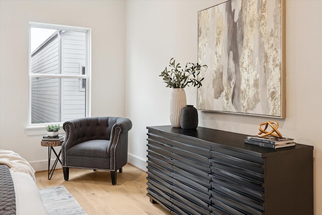 sitting room with wood finished floors and baseboards