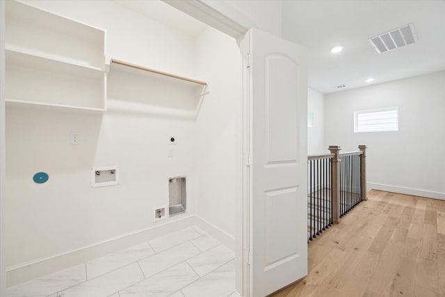 laundry area featuring laundry area, washer hookup, visible vents, baseboards, and electric dryer hookup