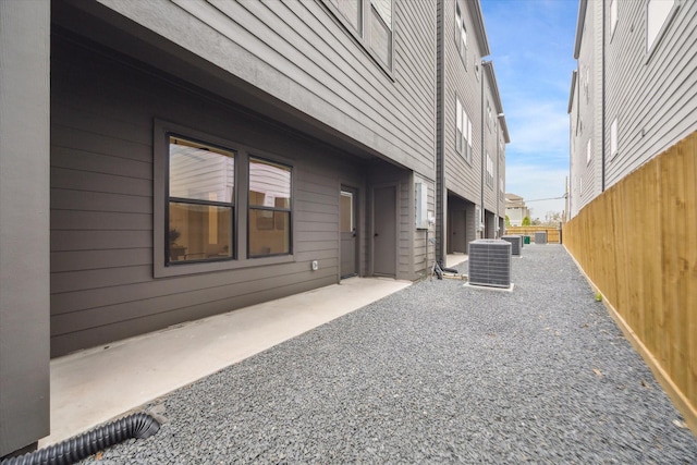 view of side of property featuring a patio area and central AC unit