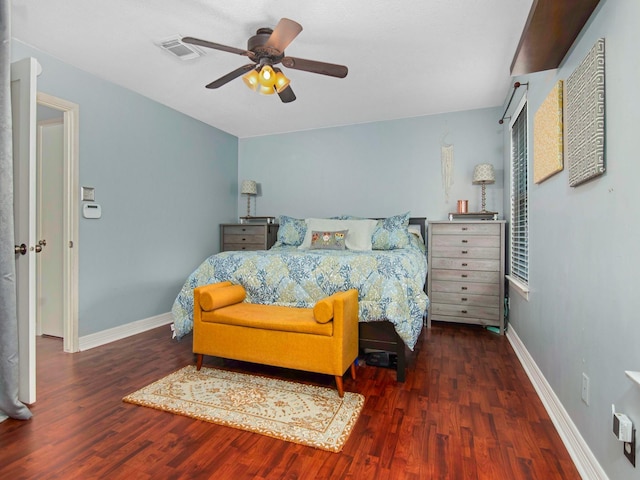 bedroom featuring visible vents, baseboards, and wood finished floors