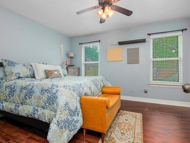 bedroom featuring a ceiling fan, baseboards, and wood finished floors