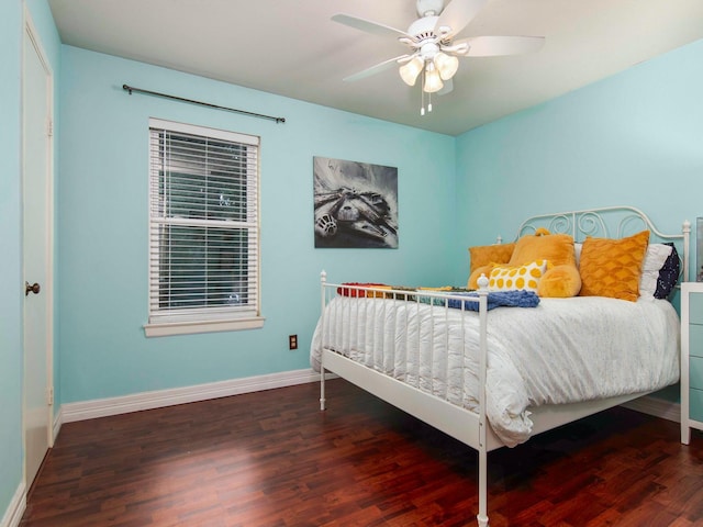 bedroom with ceiling fan, baseboards, and wood finished floors