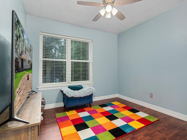 interior space with ceiling fan, baseboards, and wood finished floors