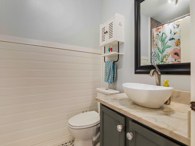 full bathroom featuring a shower with curtain, vanity, and toilet