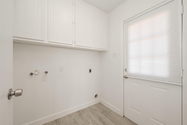 washroom featuring cabinet space, baseboards, light wood-style floors, and electric dryer hookup