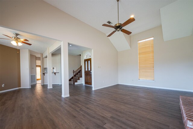 unfurnished living room with dark wood-style floors, stairway, visible vents, and baseboards