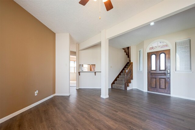 entrance foyer featuring stairs, dark wood-style flooring, and baseboards